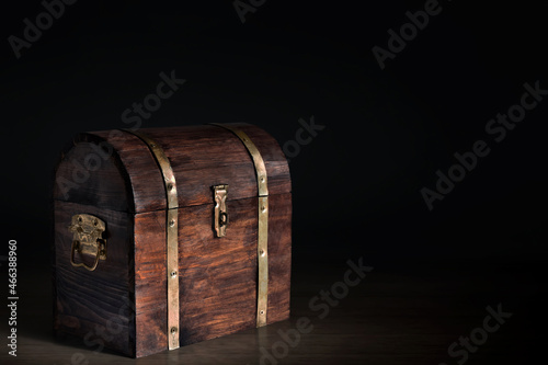 Wooden treasure chest on dark background