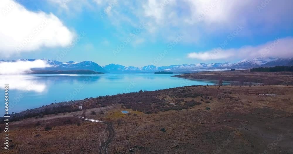 Aerial shot of Calming and relaxing Tekapo Lake in New Zealand. Epic cinematic aerial shot of flying through land near lake Tekapo. Aerial shot of Calming and relaxing Tekapo Lake in New Zealand. Epic cinematic aerial shot of flying through land near lake Tekapo.
