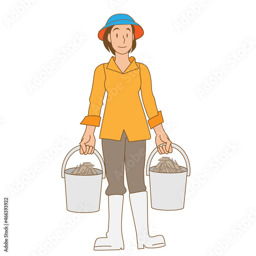 干し草を運ぶ酪農家の女性
