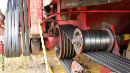 Old belt tensioner roller. Agricultural machinery belt tensioning roller with copy space. Selective focus photo