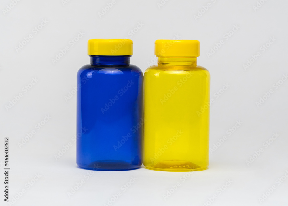 Multi colored transparent plastic pill jars on a white background. Isolated Multi colored transparent plastic pill jars on a white background. Isolated