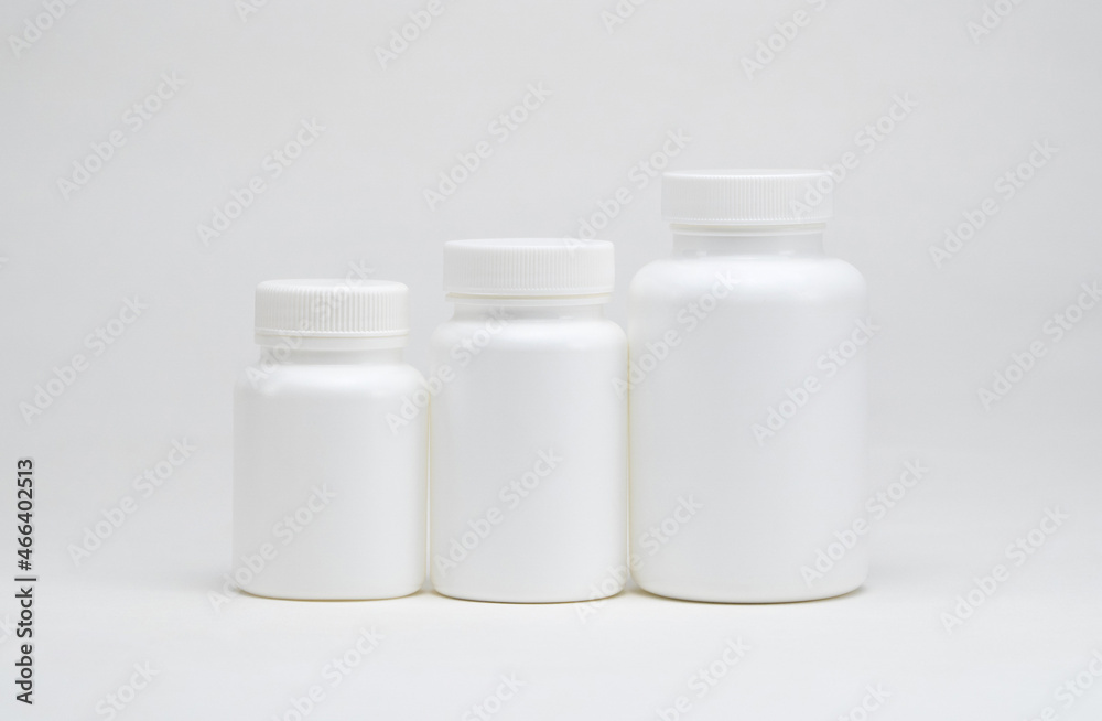 White plastic pill jars on a white background. Isolated