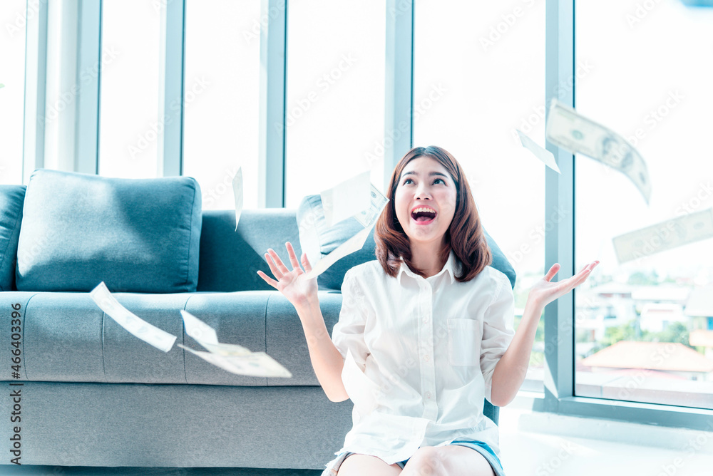 Happy young asian woman holding dollar money and throw in the air celebrate happiness dance wealth lottery money rain drop. Winner Success business woman throw cash flow Happy money smiling face Happy young asian woman holding dollar money and throw in the air celebrate happiness dance wealth lottery money rain drop. Winner Success business woman throw cash flow Happy money smiling face