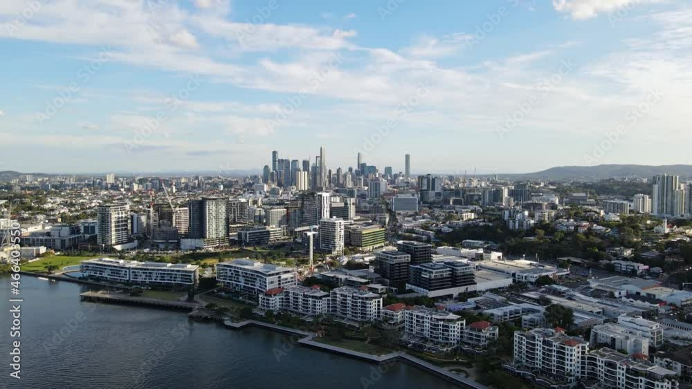 Waterfront Apartment Buildings At The Bank Of Brisbane River In Brisbane, QLD, Australia. Brisbane CBD In Distant Background. wide aerial Waterfront Apartment Buildings At The Bank Of Brisbane River In Brisbane, QLD, Australia. Brisbane CBD In Distant Background. wide aerial