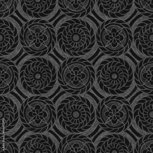 Abstract ornamental geometric seamless pattern with white contours of abstract flowers and circles on textured black background. Template for design, textile, wallpaper, wrapping, carton, ceramics.