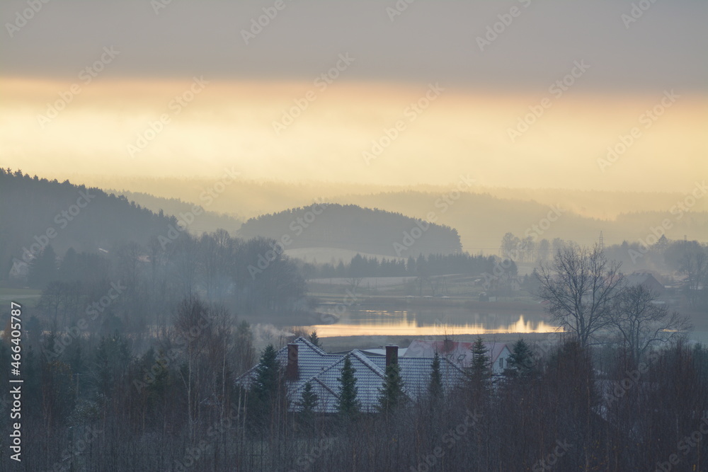 Zimowy wschód słońca nad jeziorem i lasami z mgłą - obrazy, fototapety, plakaty 
