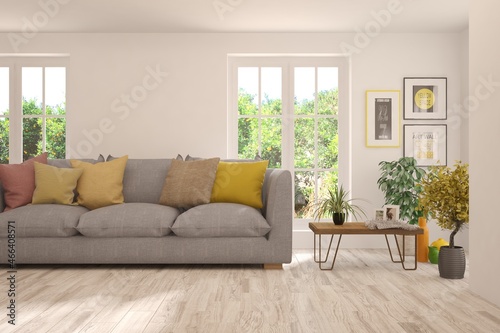 Minimalist living room in white color with sofa and summer landscape in window. Scandinavian interior design. 3D illustration