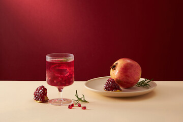Pomegranate juice in a white dish with pomegranate seed with red background , for food adverting , front view 