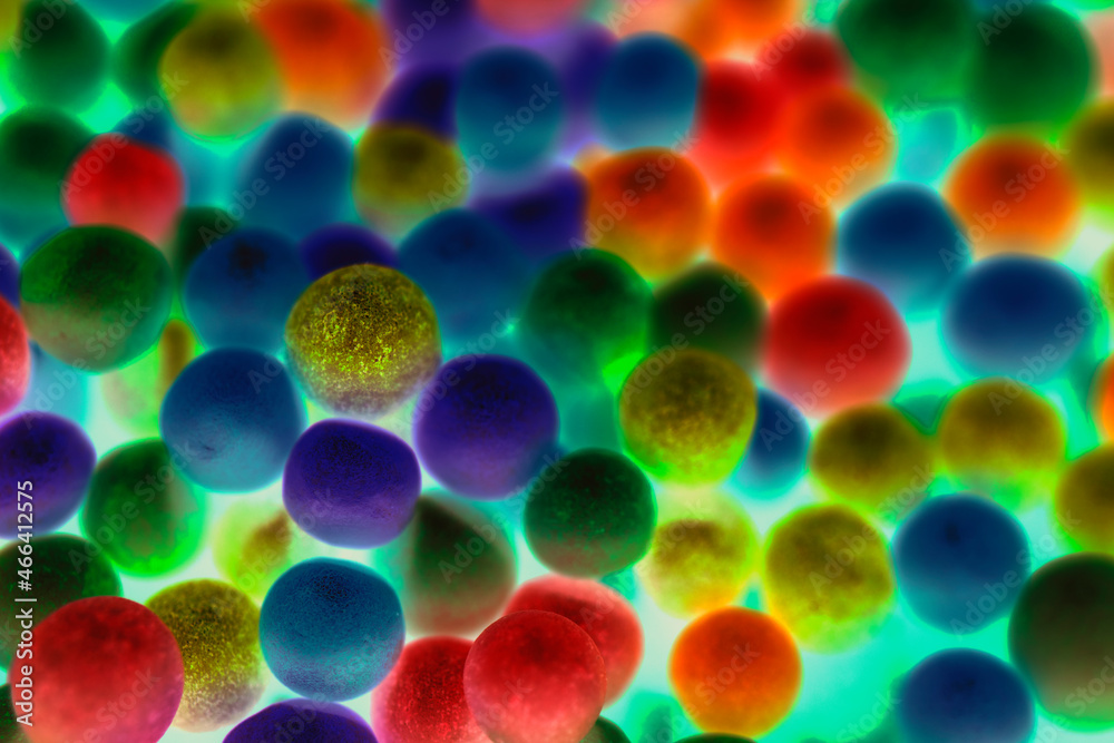 Background consisting of colorful balls with a predominance of neon colors. It looks like a microscope image.