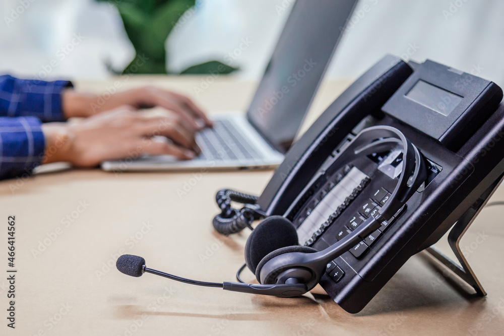 Communication support, call center and customer service help desk. telephone devices with VOIP headset in office.Customer service support (call center) concept. Communication support, call center and customer service help desk. telephone devices with VOIP headset in office.Customer service support (call center) concept.