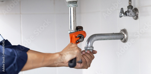 plumber at work in a bathroom, plumbing repair service, assemble and install concept.