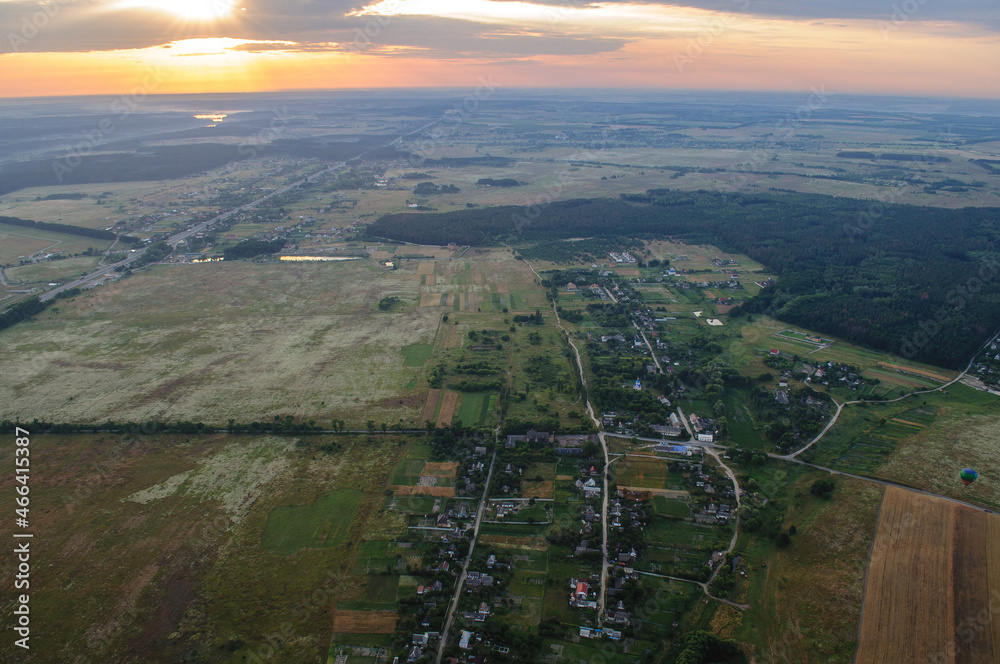 Panoramic view of the ground and sunrise from a balloon