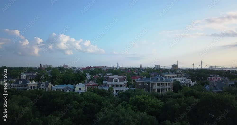 Rising drone view of a golden morning in historic Charleston, SC. Palm trees in the foreground and coastal centuries old mansions in the background. Rising drone view of a golden morning in historic Charleston, SC. Palm trees in the foreground and coastal centuries old mansions in the background.