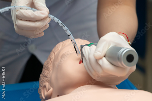 Anesthesiologist performing an orotracheal intubation on a simulation, Medical manipulation. mannequin dummy during medical training to control of the airway. photo