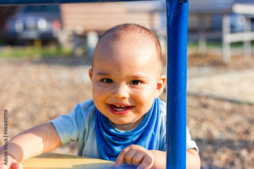 Cute happy smiling baby boy walking at children playground outdoors Cute happy smiling baby boy walking at children playground outdoors