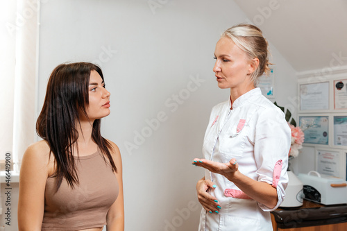 A young woman at a reception with a professional cosmetologist in a beauty salon. The concept of cosmetology and aesthetic medicine