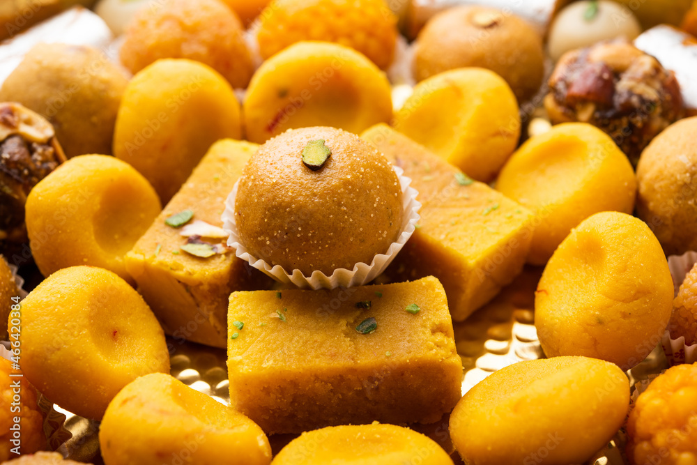 Group of Indian assorted sweets or mithai with diya Group of Indian assorted sweets or mithai with diya
