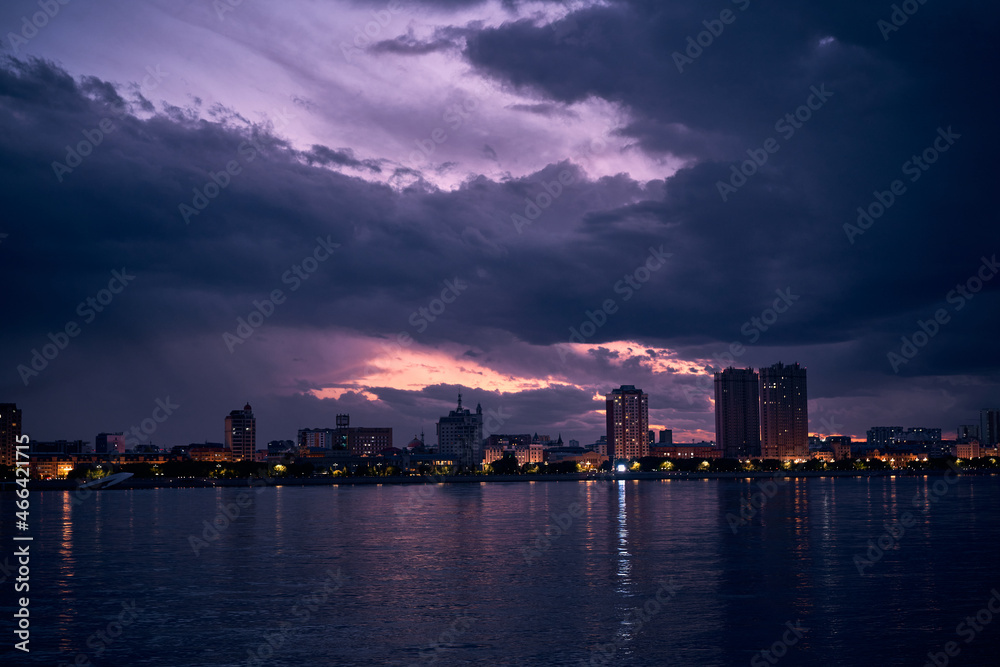 Stormy clouds over illuminated city. Blagoveshchensk, Russia