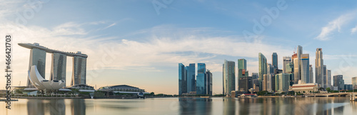 Ultra wide panorama image of Singapore skyscrapers illuminated by morning sunlight early in the morning 