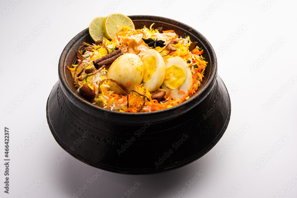 Anda biryani or egg biryani served in handi or plate Anda biryani or egg biryani served in handi or plate