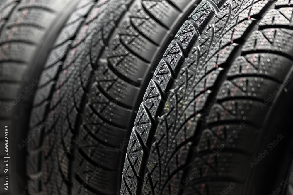 Clean car tyres spinning against dark background Clean car tyres spinning against dark background