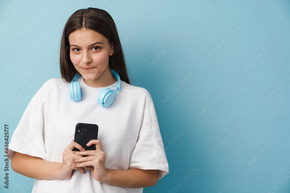 Young white woman looking at camera using mobile phone Young white woman looking at camera using mobile phone