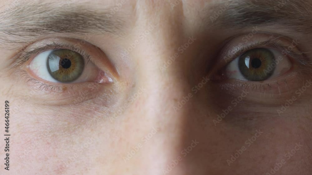 Man looks up and looks into camera. Eyes close up Man looks up and looks into camera. Eyes close up
