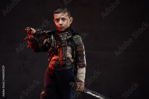 Young survivor with gun and knife in dark background