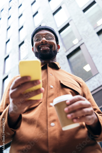 Smiling man using smart phone