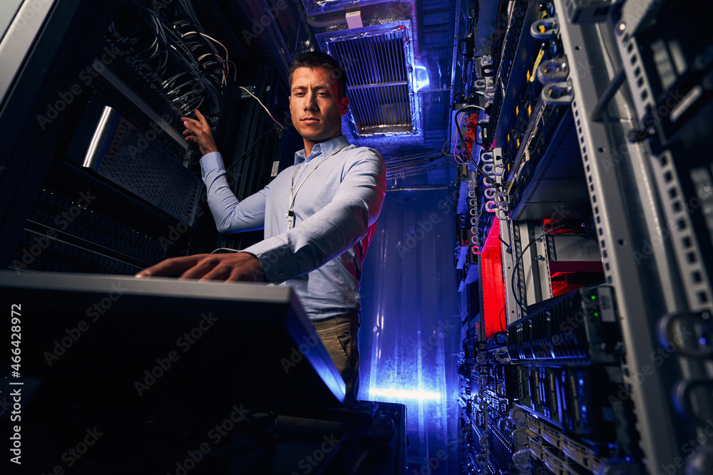 Concentrated engineer installing operating system on physical server