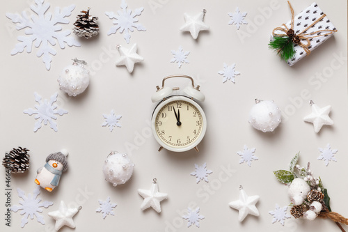 New Year's winter composition. Alarm clock Christmas gift snowflakes stars balls on a white background. Flat lay top view