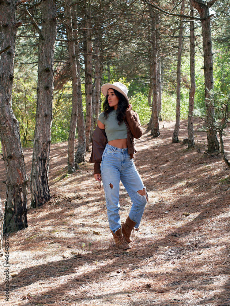 A woman in a hat travels through the forest. In the fall, walk in the woods. Walk, tourism, nature travel.
A woman in a hat travels through the forest. In the fall, walk in the woods. Walk, tourism, nature travel.
