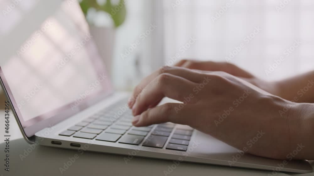 side view. Hand of woman using laptop at morning and sunlight at home side view. Hand of woman using laptop at morning and sunlight at home