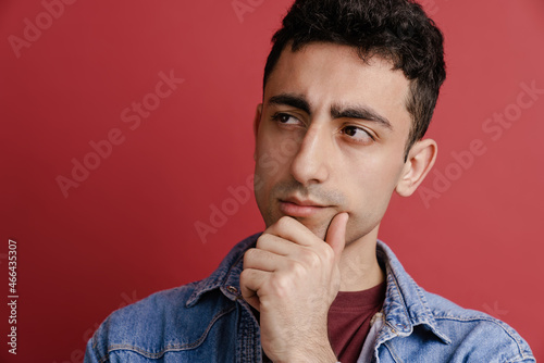 Young middle eastern man frowning and looking aside