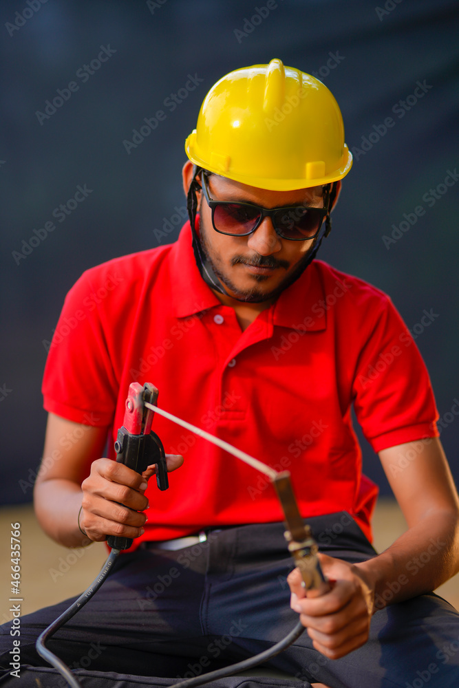 Young indian welder working at iron factory Young indian welder working at iron factory