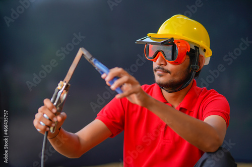 Young indian welder working at iron factory © PRASANNAPIX