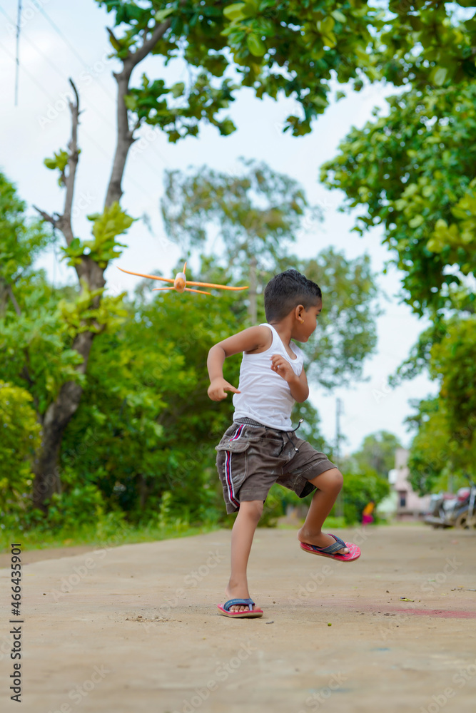 dreams of flight! indian child playing with toy airplane dreams of flight! indian child playing with toy airplane