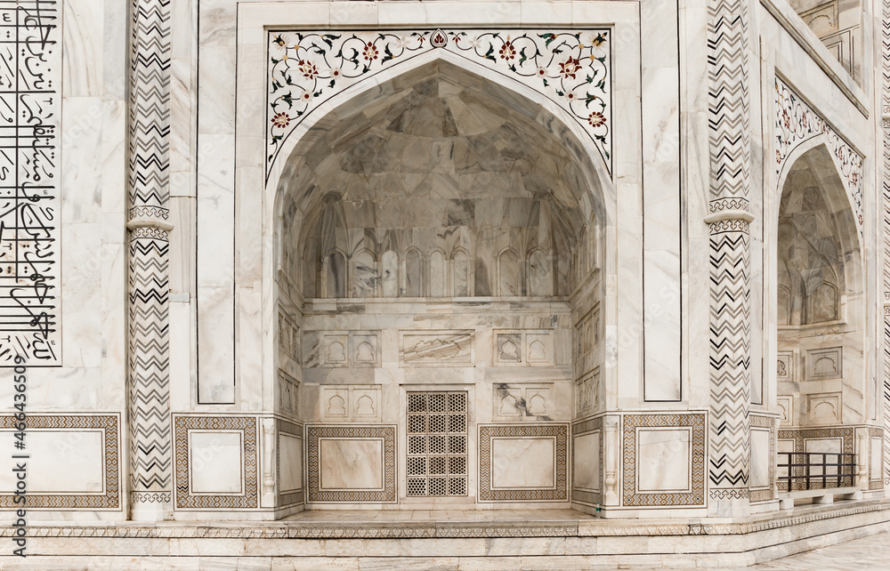 Decorated marble arch of the Taj Mahal monument in Agra, India