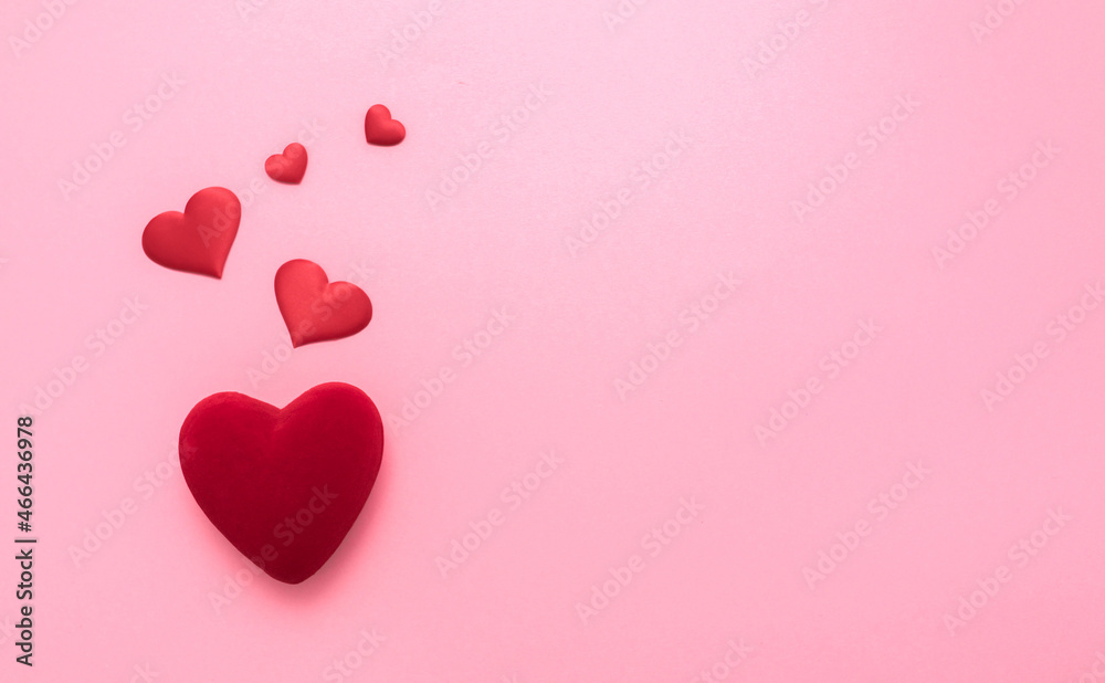 Valentine's Day. Love background. Gifts in the form of hearts on a pink background with the inscription love. Copy space for text. The concept of romance and love.