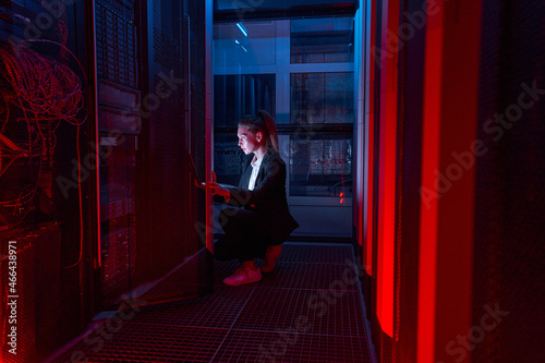 Female system manager configuring servers in server room