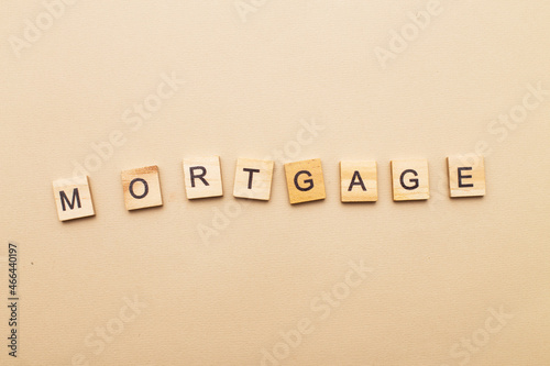 inscription mortgage on a beige background made by wooden blocks