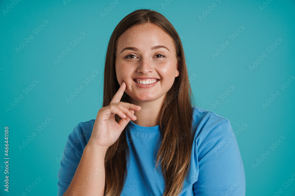 Young white woman wearing t-shirt smiling and looking at camera Young white woman wearing t-shirt smiling and looking at camera