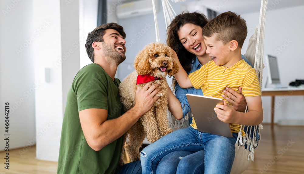 Happy family using technology devices together at home.