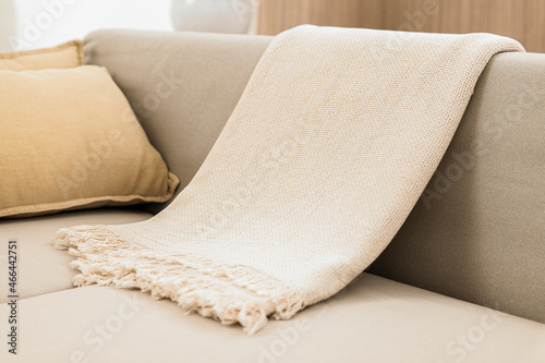 White woven throw blanket on sofa