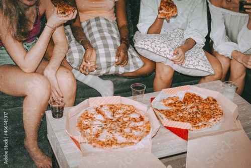 Friends eating pizza, hanging out at a sleepover party photo