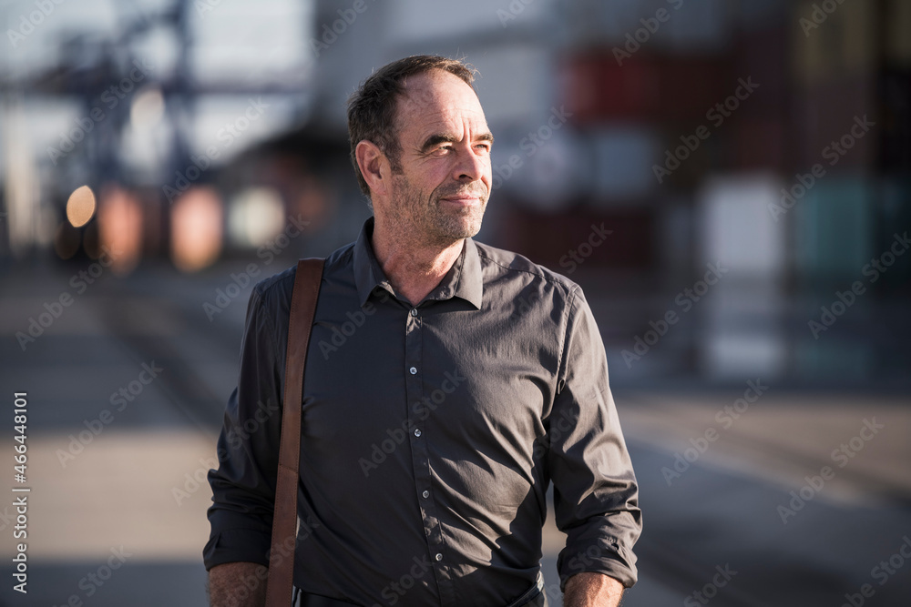 Mature businessman walking on street Mature businessman walking on street