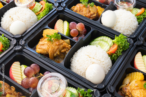 Thai food lunch boxes in plastic packages. Rice with Thai chicken massaman curry. photo