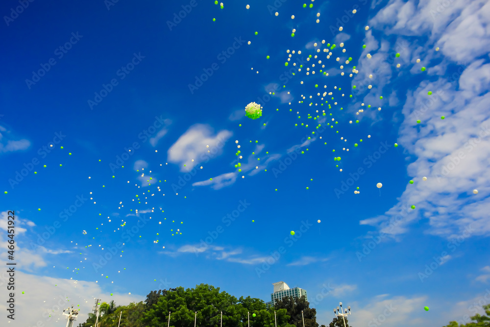 the release of hundreds of helium balloons into the air as a symbol in ...