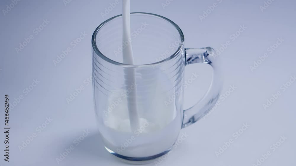 Glass of milk in slow motion. Pouring milk in a transparent glass. Footage in 4K Glass of milk in slow motion. Pouring milk in a transparent glass. Footage in 4K