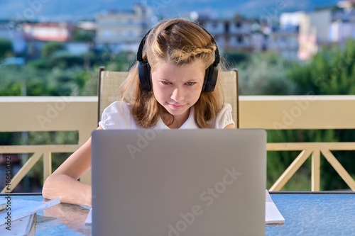 Girl child 10, 11 years old studying at home online